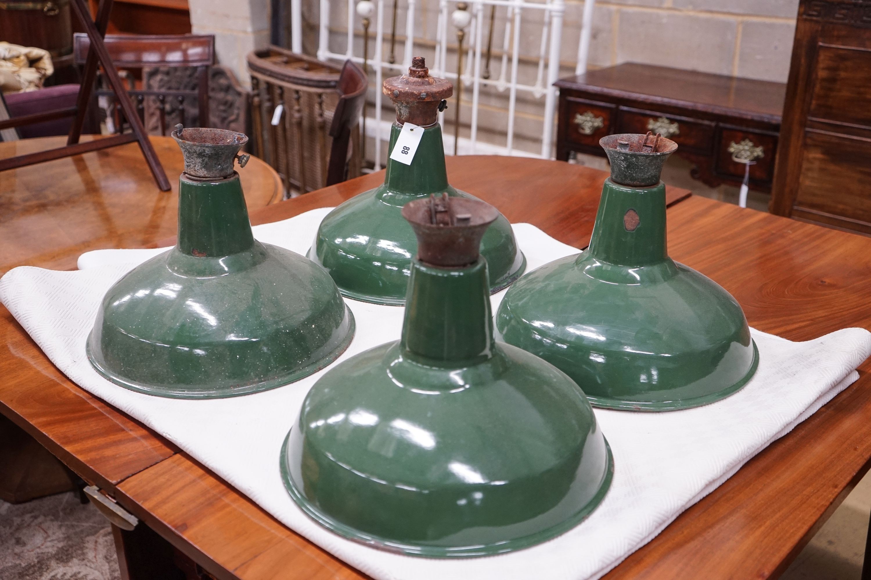 A set of four industrial style green enamelled ceiling shades, diameter 36cm